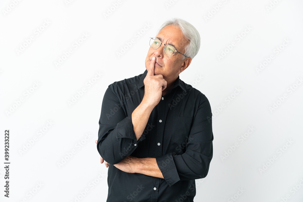 Middle age Brazilian man isolated on white background having doubts while looking up Middle age Brazilian man isolated on white background having doubts while looking up