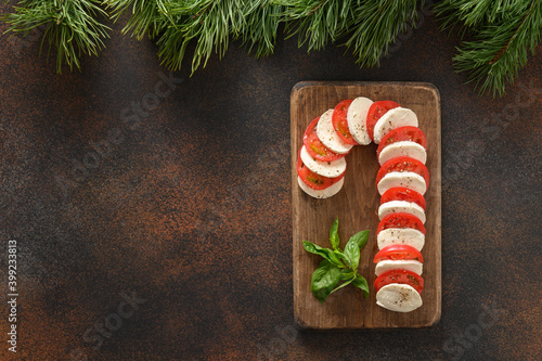 Caprese candy cane salad is holiday appetizer for festive Xmas party. View from above. Copy space. photo