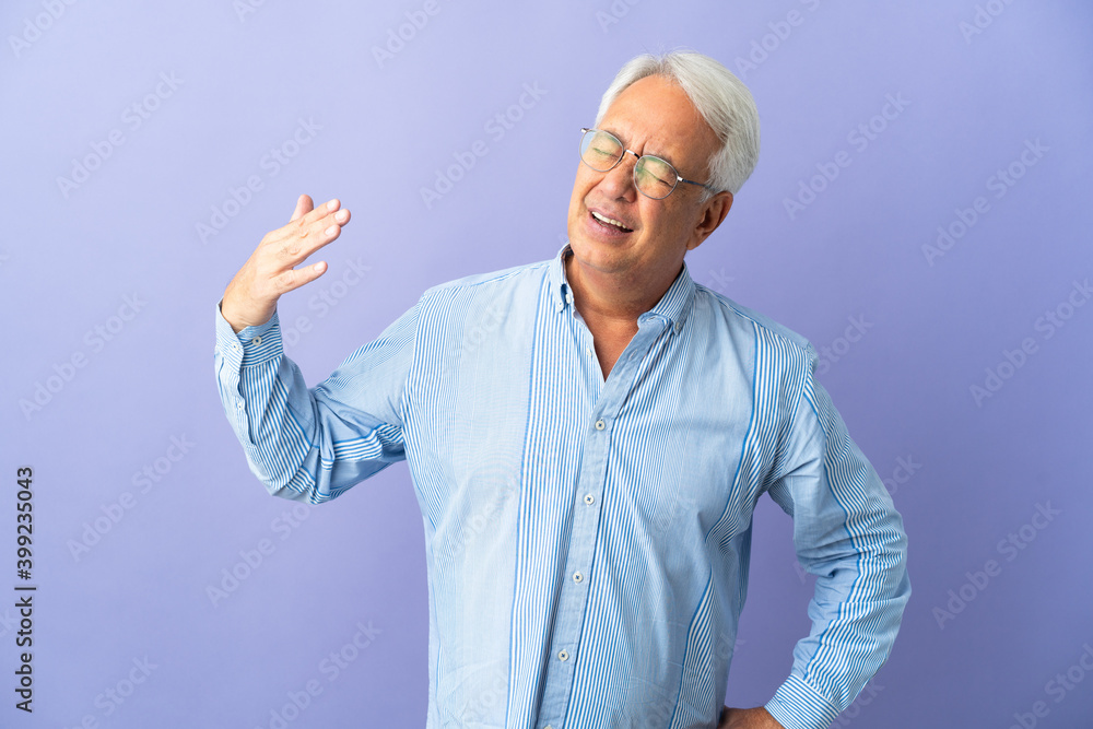 Middle age Brazilian man isolated on purple background with tired and sick expression Middle age Brazilian man isolated on purple background with tired and sick expression