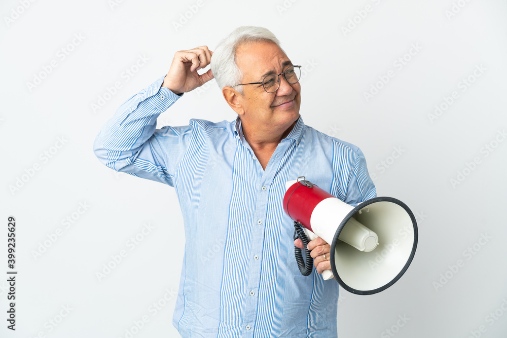 Middle age Brazilian man isolated on white background holding a megaphone and having doubts Middle age Brazilian man isolated on white background holding a megaphone and having doubts