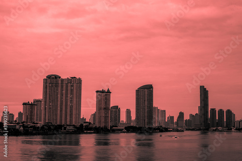 Blurred abstract background of high-rise buildings built by the river, lit at night, the distribution of residences of today's capital so