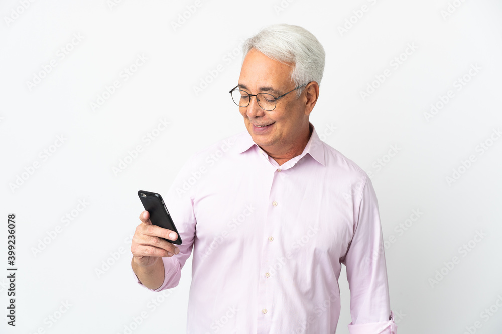 Middle age Brazilian man isolated on white background sending a message or email with the mobile Middle age Brazilian man isolated on white background sending a message or email with the mobile