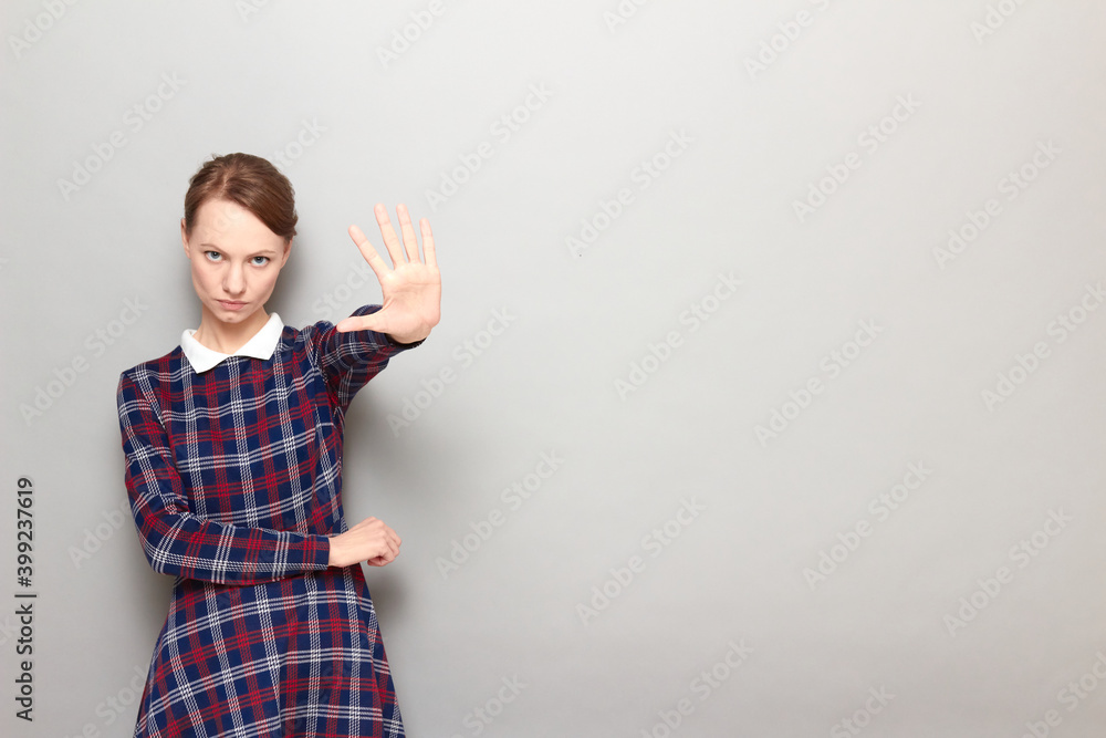 Girl is showing number five with fingers or rejecting something Girl is showing number five with fingers or rejecting something