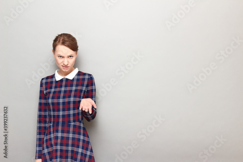 Portrait of disgruntled girl with frowning face making demands photo