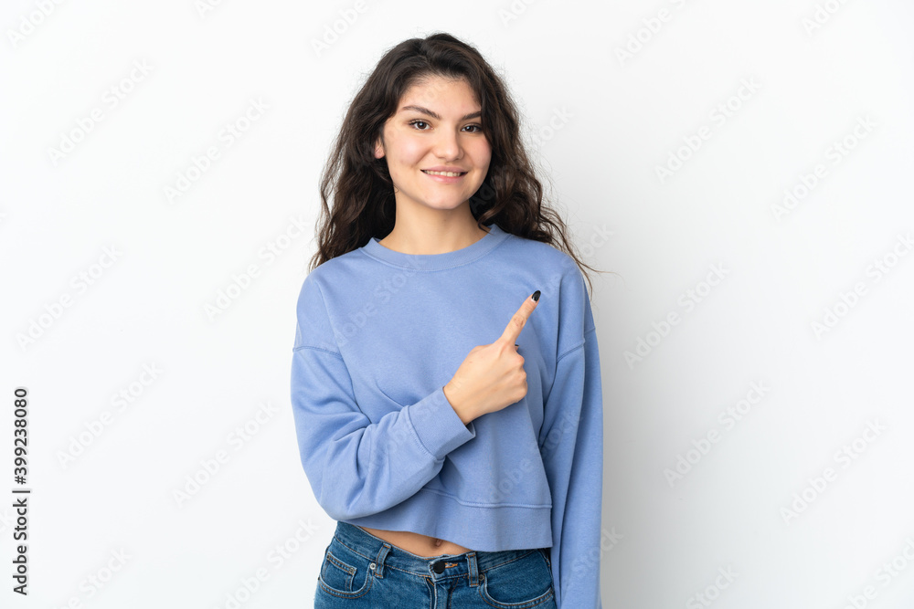 Teenager Russian girl isolated on white background pointing to the side to present a product Teenager Russian girl isolated on white background pointing to the side to present a product
