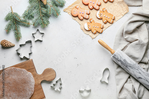 Gingerbread cookies, fresh dough and cutters on white background