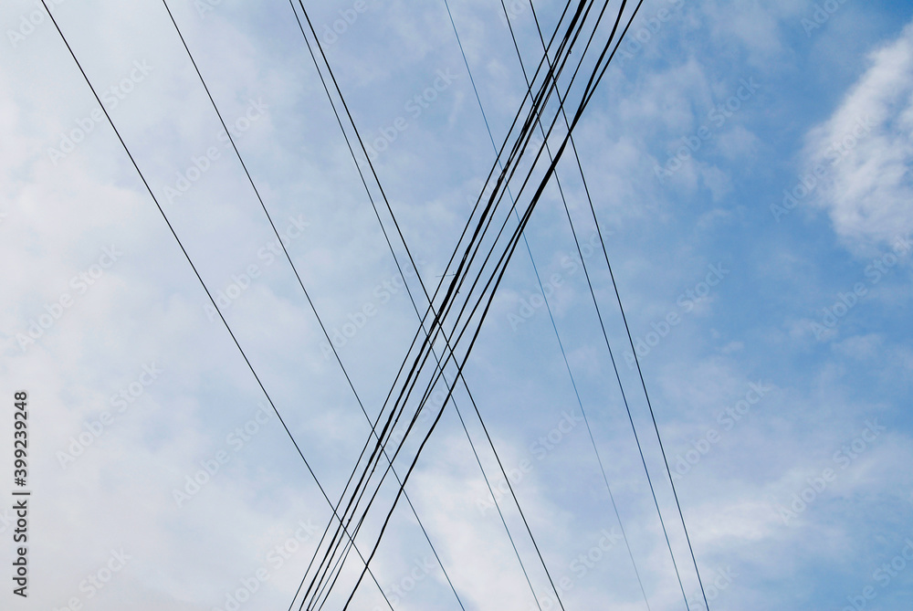 Electricity cables against the blue sky background. Electricity cables against the blue sky background.