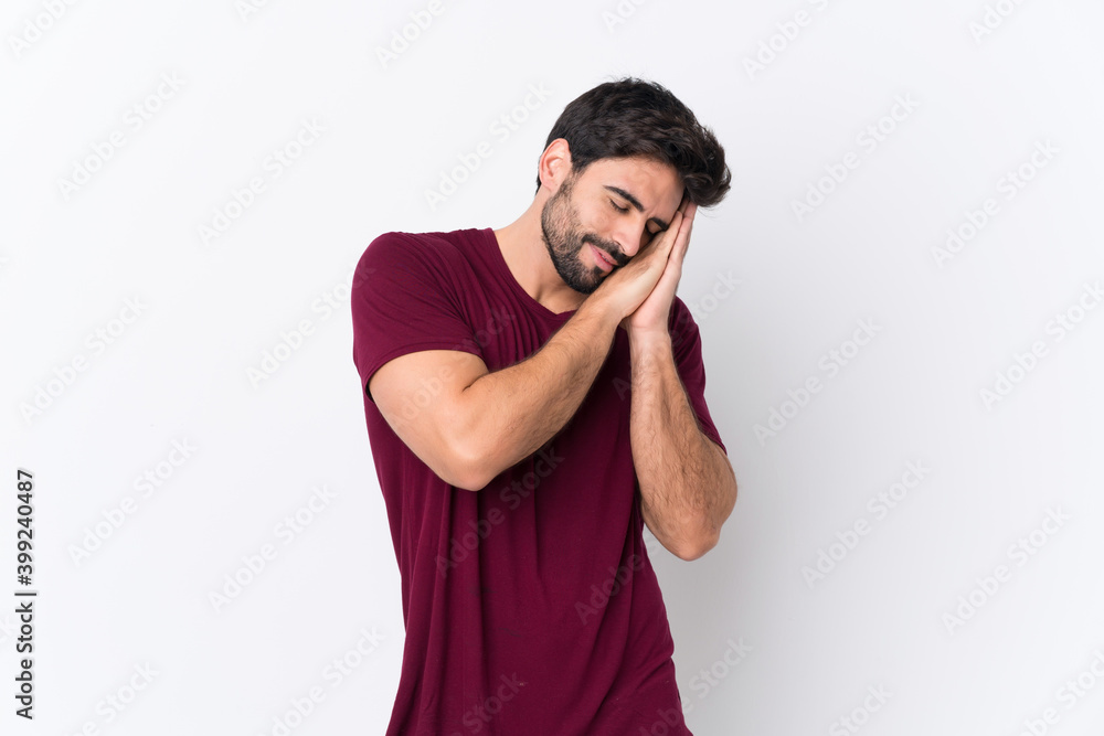 Young handsome man with beard over isolated white background making sleep gesture in dorable expression Young handsome man with beard over isolated white background making sleep gesture in dorable expression