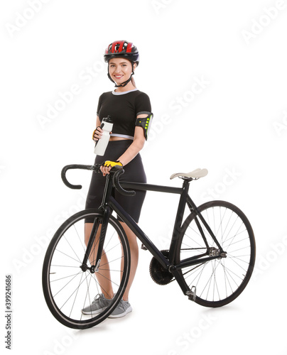 Female cyclist with bicycle and bottle of water on white background
