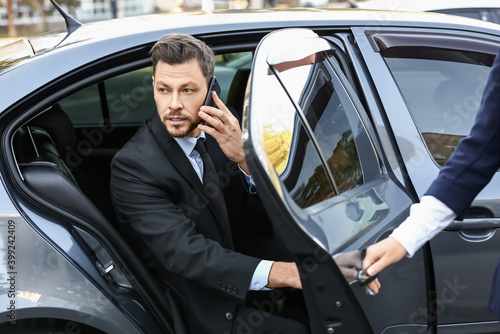 Obraz na plátně Businessman getting out of luxury car