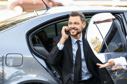 Businessman getting out of ...
