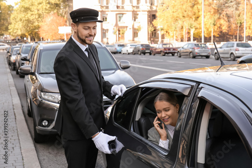 Chauffeur opening car door ...