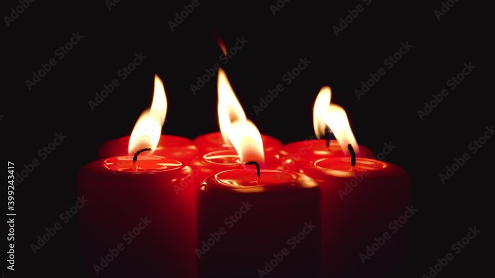Burning Red Candles Grouped Together in Round on Black Background Rotating. Romantic Atmosphere with Scented Aroma Light Candles. Somebody Wind Try to Blown Out all Flame in the Dark Burning Red Candles Grouped Together in Round on Black Background Rotating. Romantic Atmosphere with Scented Aroma Light Candles. Somebody Wind Try to Blown Out all Flame in the Dark