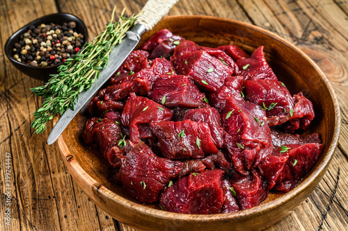 Canvastavla Raw cut wild venison meat for a goulash in a wooden plate