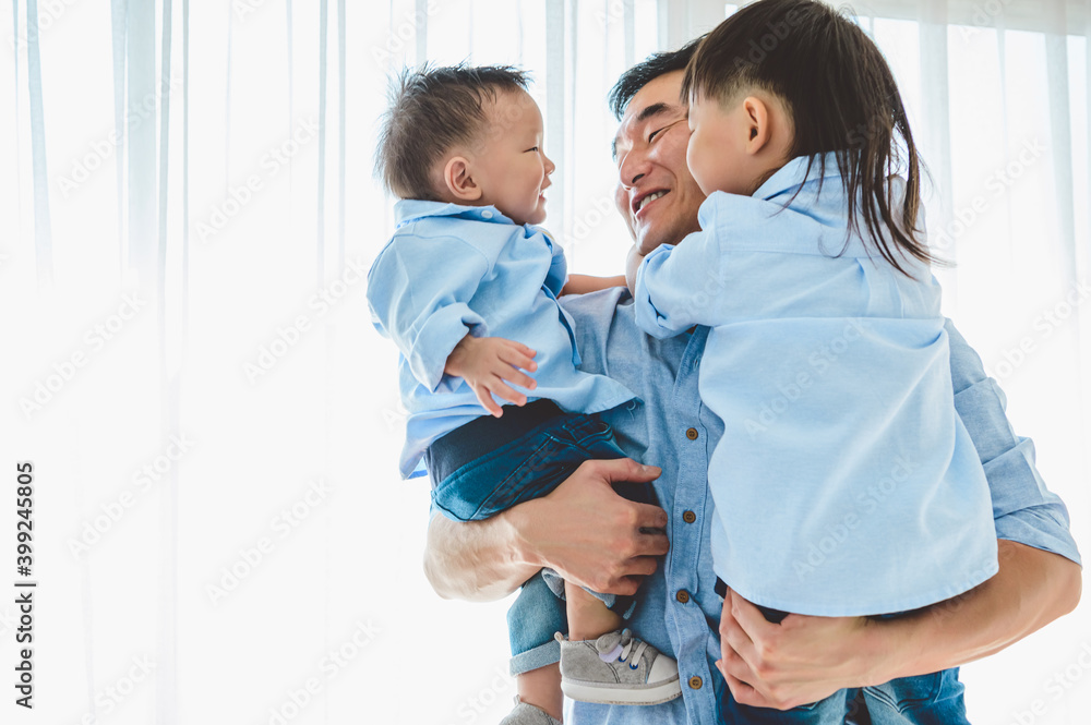Happy father carrying two children in bedroom at their house. Family living and having positive expression emotion togetherness. Leisure time. People lifestyle health. Quarantine Covid-19 Coranavirus