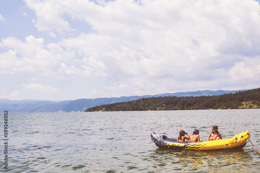 Happy children have summer fun on water, kayaking, beautiful nature landscape