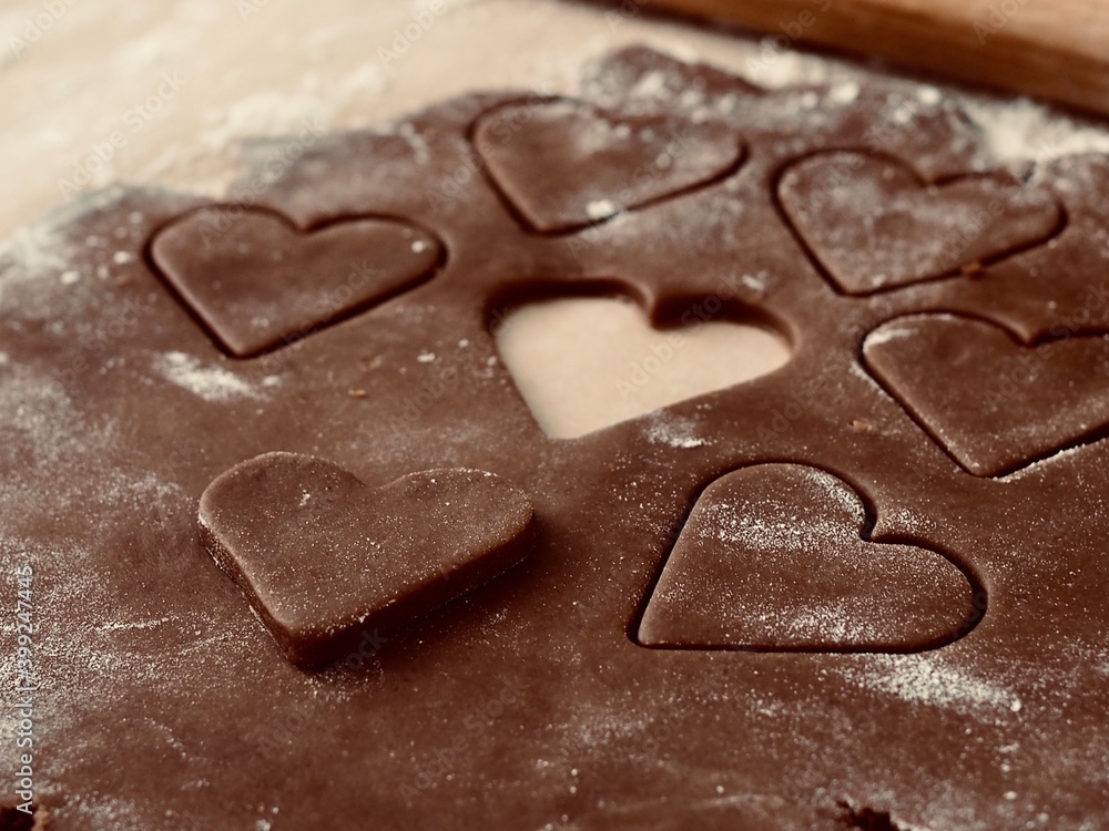 Valentine's day. Cutting out hearts from rolled dough for making Christmas cookies. Valentine's day. Cutting out hearts from rolled dough for making Christmas cookies.