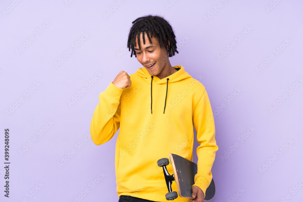 Handsome young skater man over isolated wall celebrating a victory Handsome young skater man over isolated wall celebrating a victory