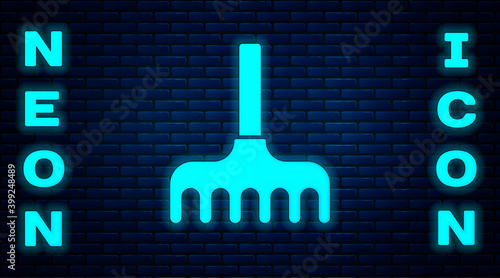 Glowing neon Garden rake icon isolated on brick wall background. Tool for horticulture, agriculture, farming. Ground cultivator. Vector Illustration.