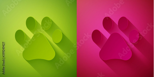 Paper cut Paw print icon isolated on green and pink background. Dog or cat paw print. Animal track. Paper art style. Vector.