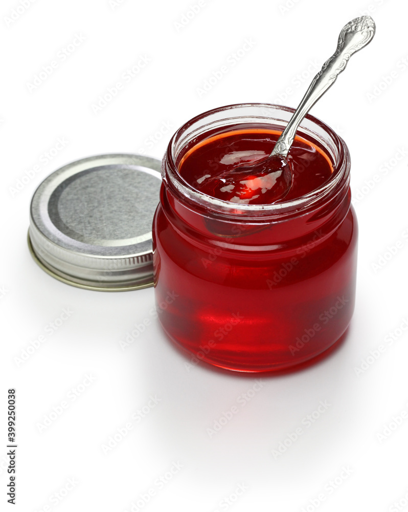 homemade quince jelly in glass jar isolated on white backfground homemade quince jelly in glass jar isolated on white backfground