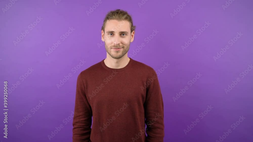 portrait of young long-haired man showing ok gesture isolated on purple background. 4K portrait of young long-haired man showing ok gesture isolated on purple background. 4K