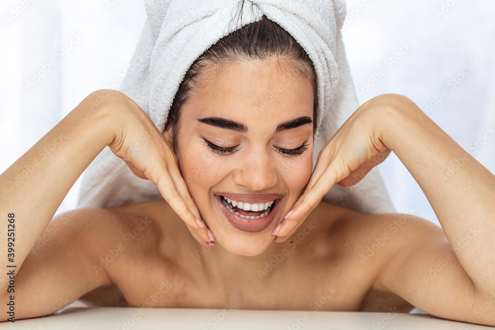 Skin care. Woman with beauty face touching healthy facial skin portrait. Beautiful smiling asian girl model with natural makeup touching glowing hydrated skin on white background closeup Skin care. Woman with beauty face touching healthy facial skin portrait. Beautiful smiling asian girl model with natural makeup touching glowing hydrated skin on white background closeup