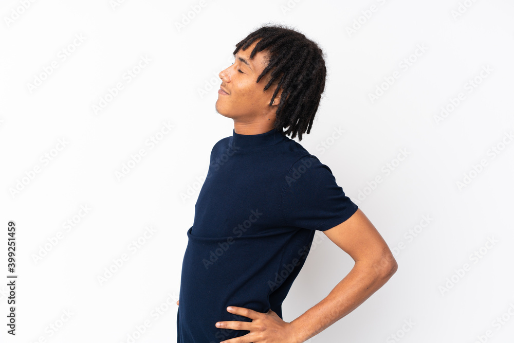 Young african american man isolated on white background suffering from backache for having made an effort Young african american man isolated on white background suffering from backache for having made an effort