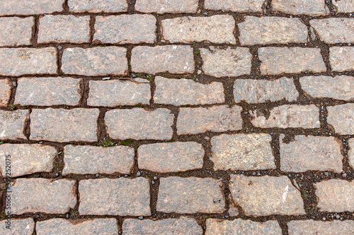Old wet granite cobblestone road