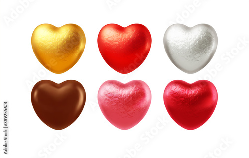 Set of realistic heart shaped chocolates wrapped in foil candy wrapper. Festive design element for Happy Valentines Day. Vector illustration