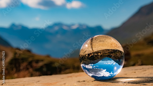 Crystal ball alpine landscape shot at the famous Timmelsjoch high alpine road, Dolomites, South Tyrol, Italy © Martin Erdniss