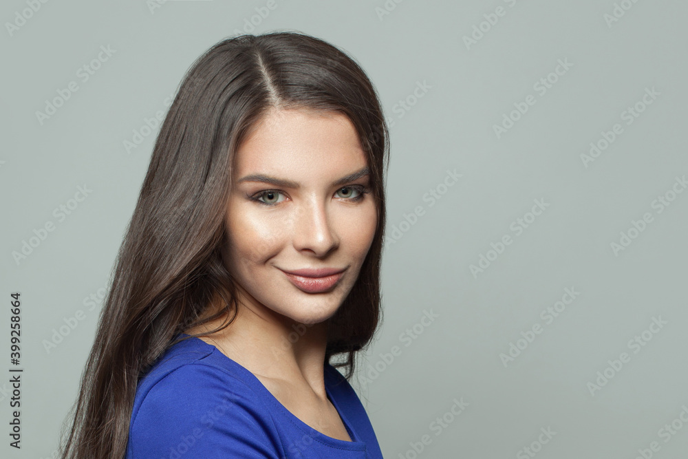 Beautiful brunette woman face with healthy skin and dark hair on white background Beautiful brunette woman face with healthy skin and dark hair on white background