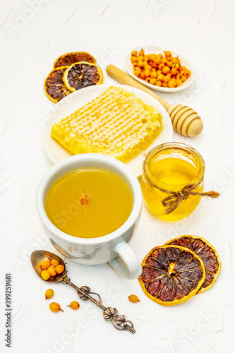 Healing sea-buckthorn tea with honeycombs and lemon