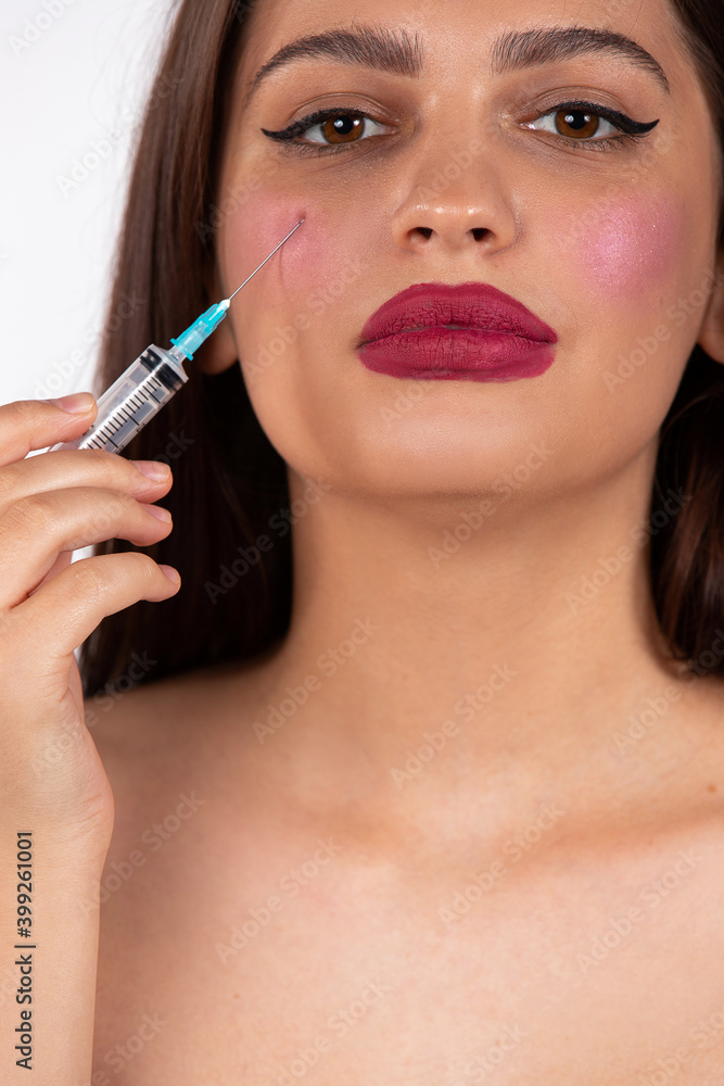Enlarged photo. Caucasian girl with big red lips and cosmetic injection. New normal beauty Enlarged photo. Caucasian girl with big red lips and cosmetic injection. New normal beauty