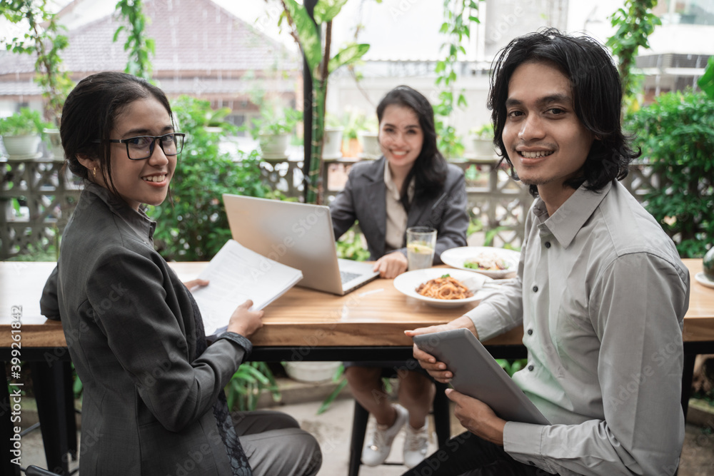 Portrait of young asian business team meeting in a cafe together Portrait of young asian business team meeting in a cafe together