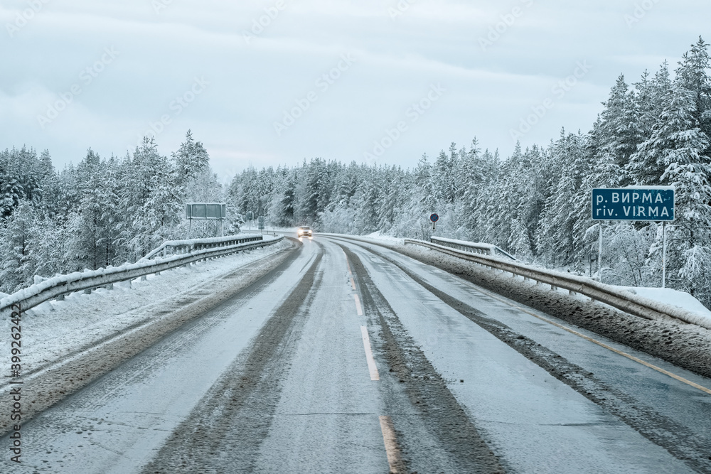 Fototapeta premium Slippery snowy Northern winter road, turn on the road. Kola Peninsula.