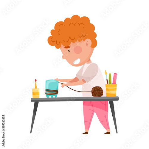 Creative Boy at Desk Crafting from Used Plastic Bottle Vector Illustration