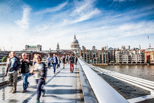 blurred image of people walking on Millenium bridge  London