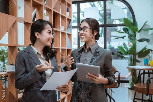 Portrait cheerful of young asian business woman meeting in a cafe. photo