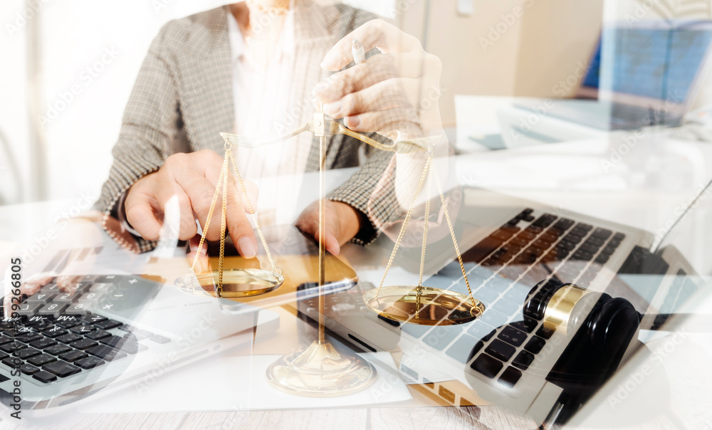 Business and lawyers discussing contract papers with brass scale on desk in office. Law, legal services, advice, justice and law concept picture with film grain effect