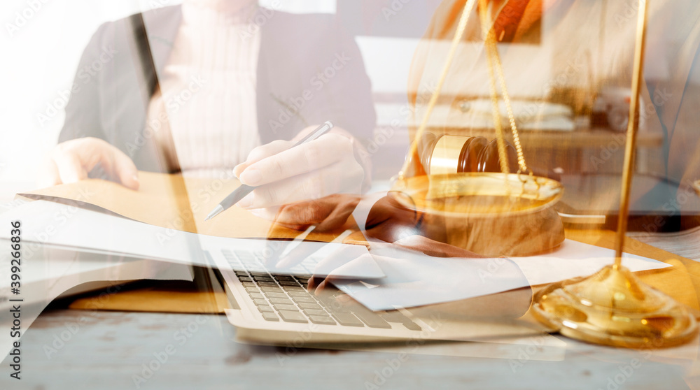 Business and lawyers discussing contract papers with brass scale on desk in office. Law, legal services, advice, justice and law concept picture with film grain effect