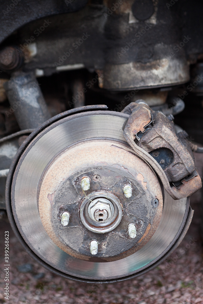 Old steel ventilated brake disk with used brake pads are ready for removing, rear wheel Old steel ventilated brake disk with used brake pads are ready for removing, rear wheel