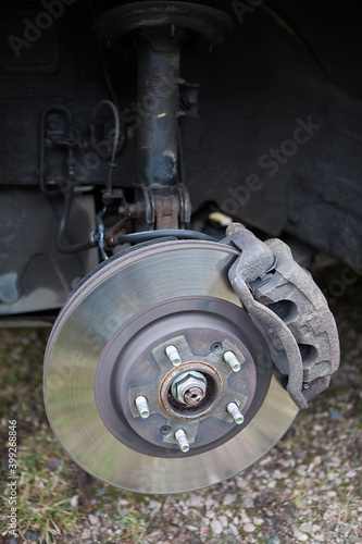 Old steel ventilated brake disk with fixed calliper and brake pads are ready for removing, front wheel © Kekyalyaynen