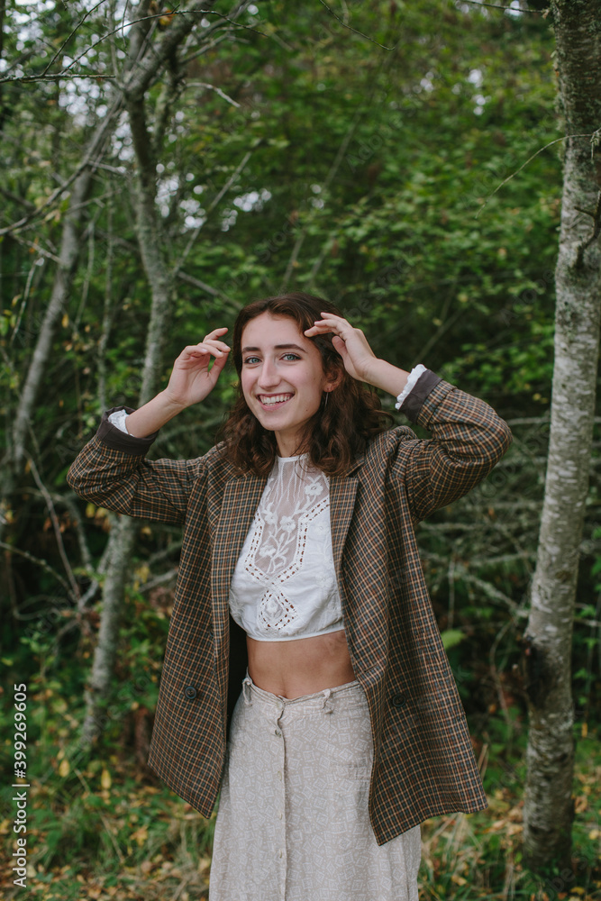 Portrait of happy seventeen year old girl standing in lush forest in Fall, Discovery Park, Seattle, Washington Portrait of happy seventeen year old girl standing in lush forest in Fall, Discovery Park, Seattle, Washington