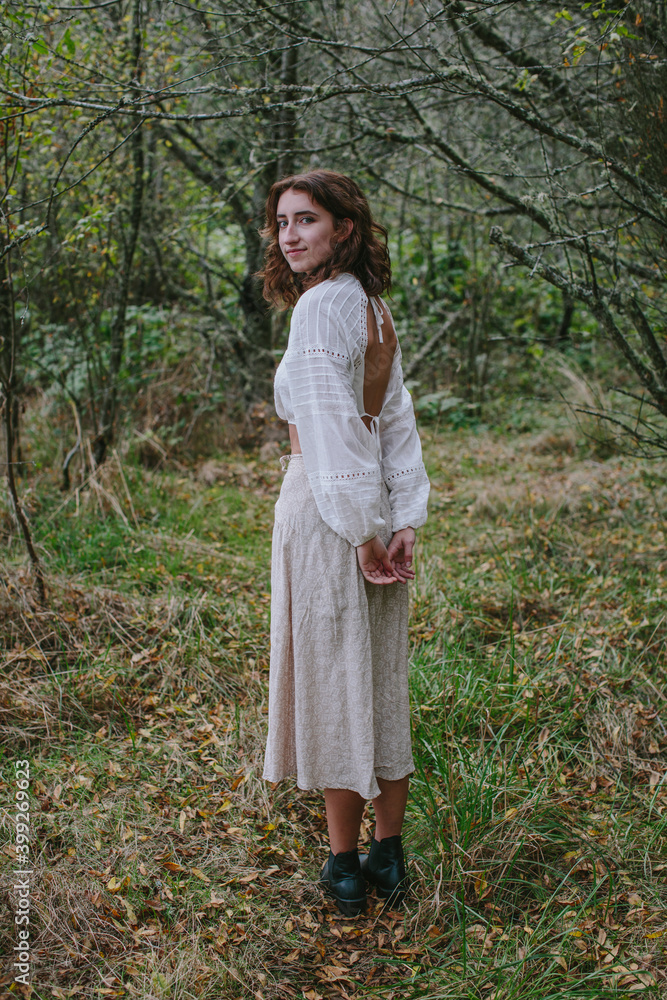 Portrait of seventeen year old girl standing in lush forest in Fall, Discovery Park, Seattle, Washington Portrait of seventeen year old girl standing in lush forest in Fall, Discovery Park, Seattle, Washington