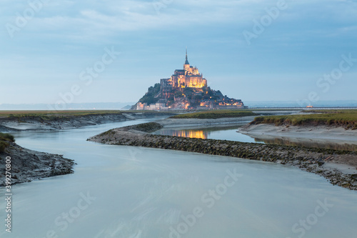 Mont St Michel at dusk on the tidal estuary