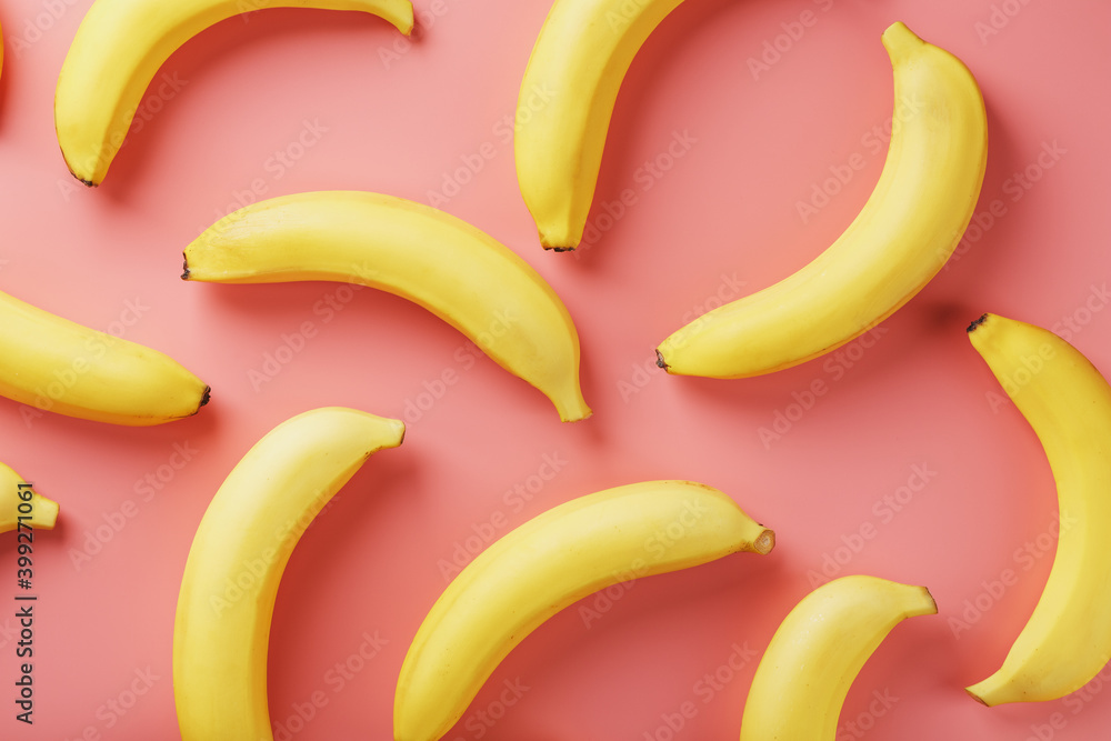 Bright pattern of yellow bananas on a pink background. Bright pattern of yellow bananas on a pink background.