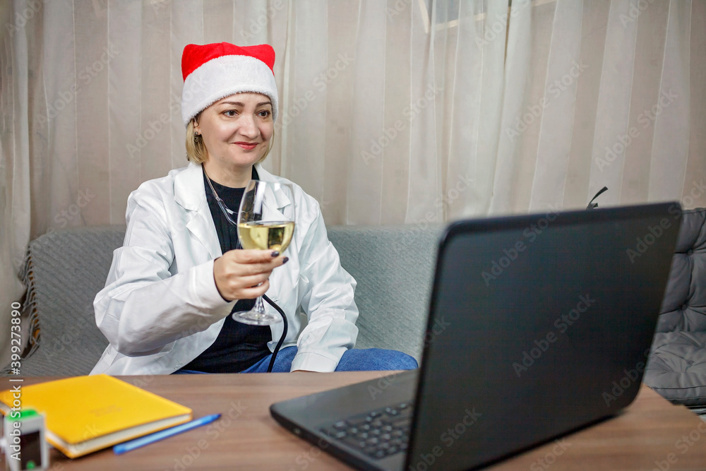 A doctor in white medical overall celebrating winter holiday and working at the same time A doctor in white medical overall celebrating winter holiday and working at the same time