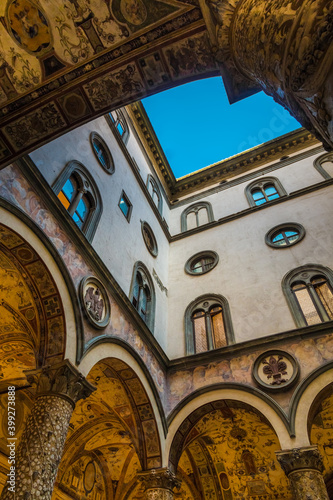Lovely low-angle view of the charming inner courtyard in the Palazzo Vecchio, Florence. The columns are covered in gilt and stucco while the cross vault ceiling was embellished by Marco da Faenza. photo