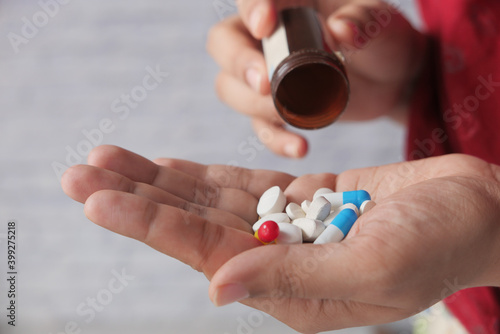 Close up of women hand taking pills  photo